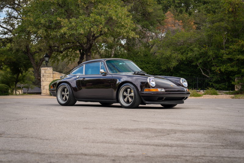 Aubergine metallic 1990 Singer Porsche 911 with five-spoke rims.