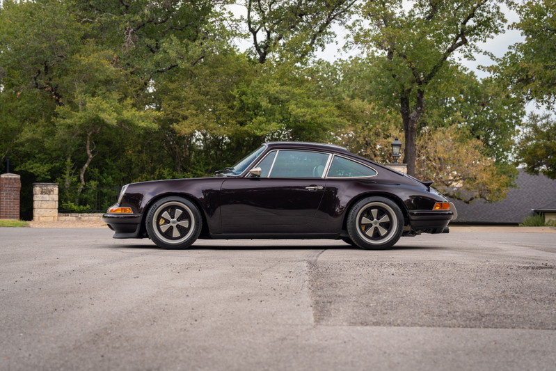 Aubergine metallic 1990 Singer Porsche 911 profile with Fuchs style rims.