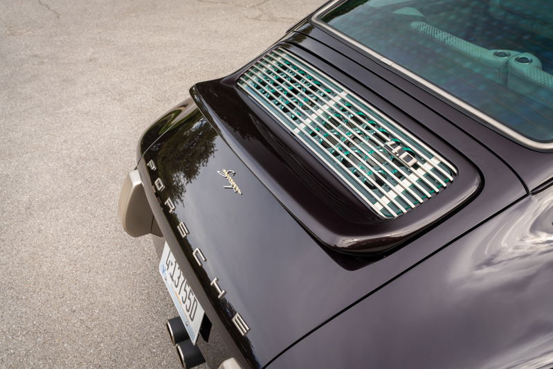 Close-up of a purple metallic 1990 Singer Porsche 911's rear engine lid.