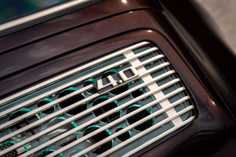 Close up of a Singer 911's aubergine metallic rear grille with "4.0" badging.