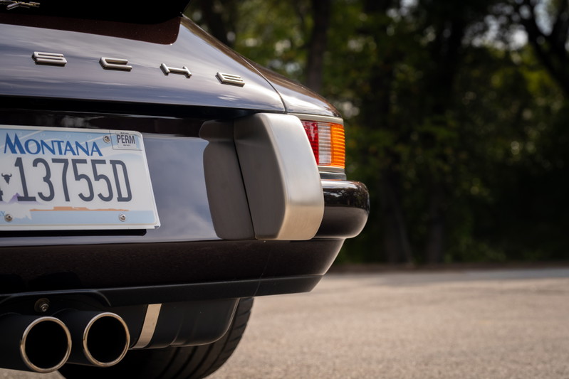 Aubergine metallic 1990 Singer 911 rear with dual exhaust pipes and Montana license plate.
