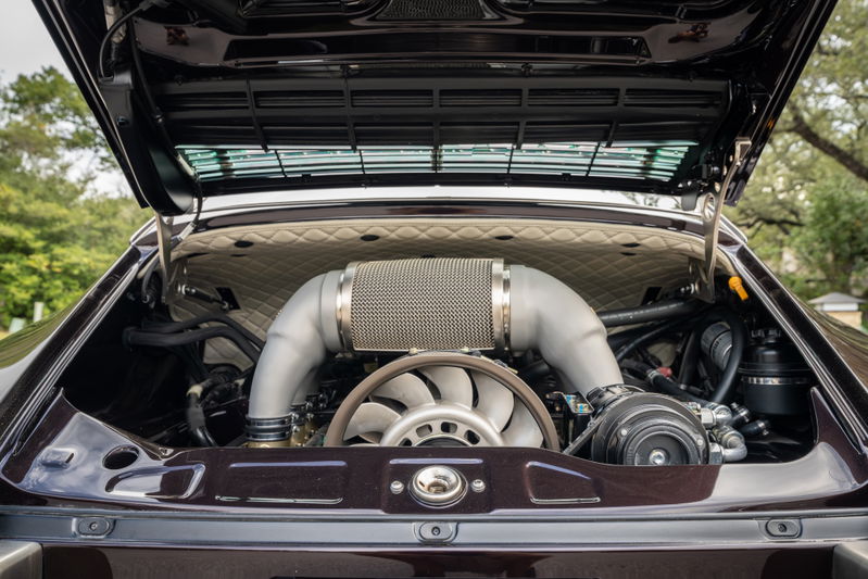 Aubergine metallic 1990 Singer 911 engine bay with quilted trim and turbocharger.