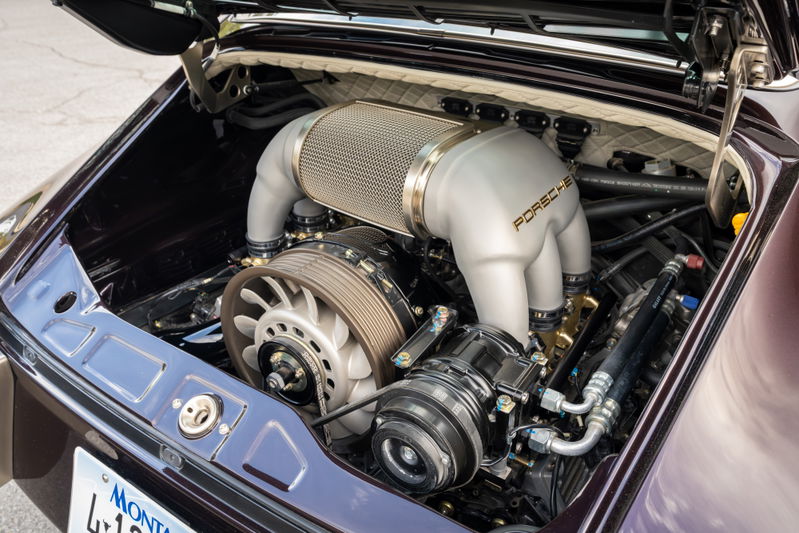 Aubergine metallic 1990 Singer Porsche 911 engine bay with Porsche badging on intake.