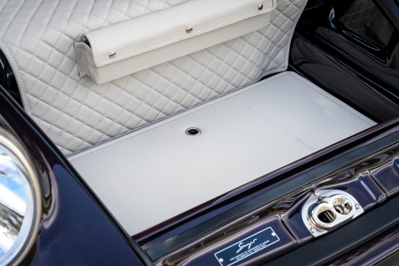 Aubergine metallic Singer Porsche 911 trunk lined with diamond-stitched cream leather.