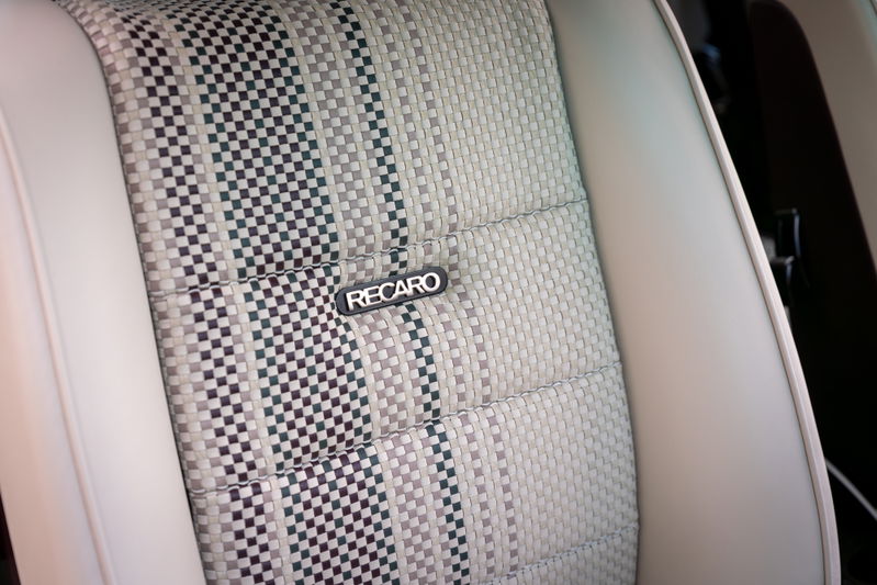 1990 Porsche 911 Singer in Aubergine Metallic features a Recaro seat with checkered fabric insert.