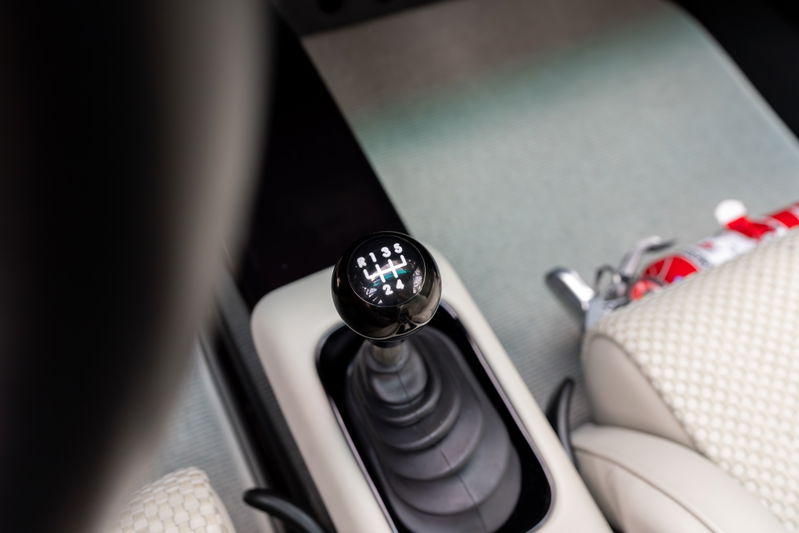 Interior shot of a 1990 Singer Porsche 911 with a 6-speed manual shifter.
