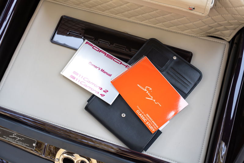 Singer Porsche 911 Aubergine Metallic owner's manual and service book inside car.