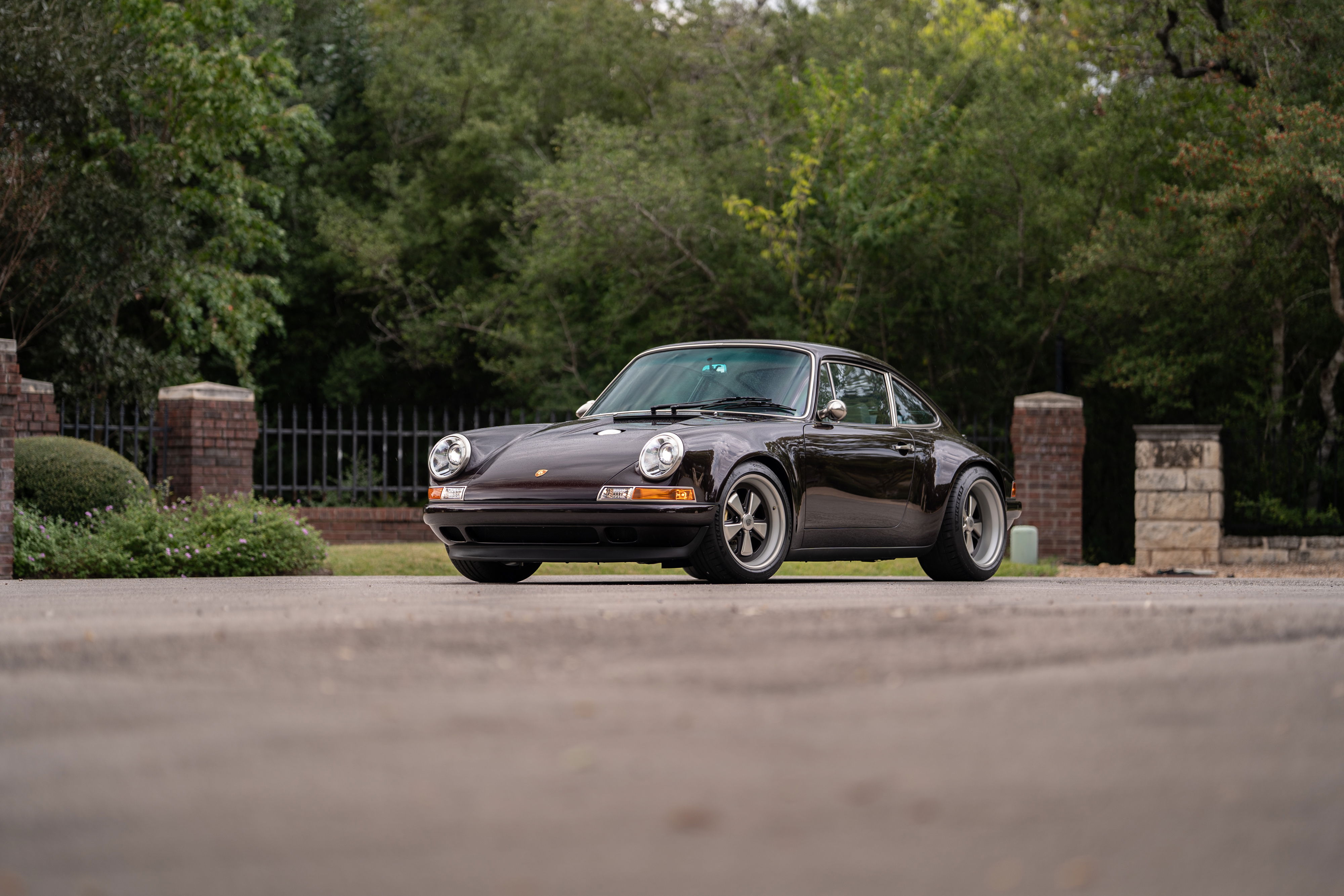 1990 Singer Porsche 911 in Aubergine Metallic, with Fuchs-style rims.