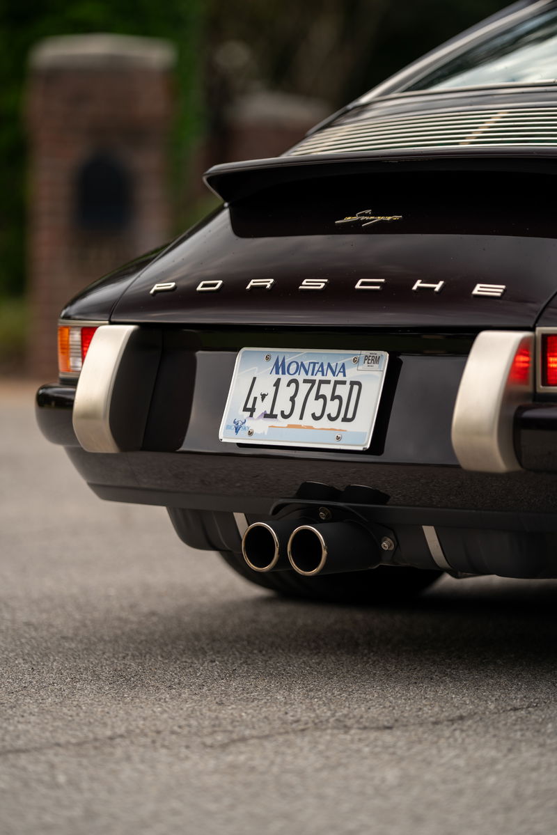 Aubergine metallic 1990 Singer Porsche 911 rear with gold script badging & dual exhaust.