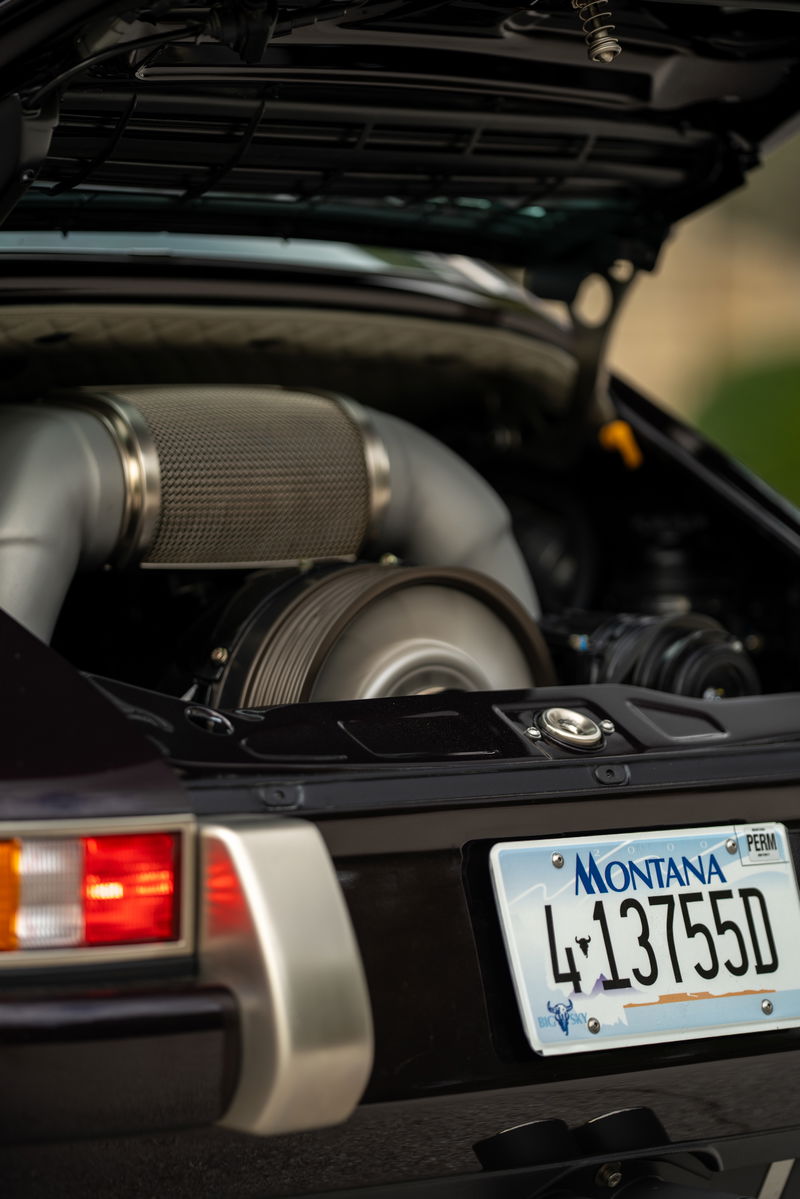 1990 Singer 911 in Aubergine Metallic showing turbocharger and polished metal trim.