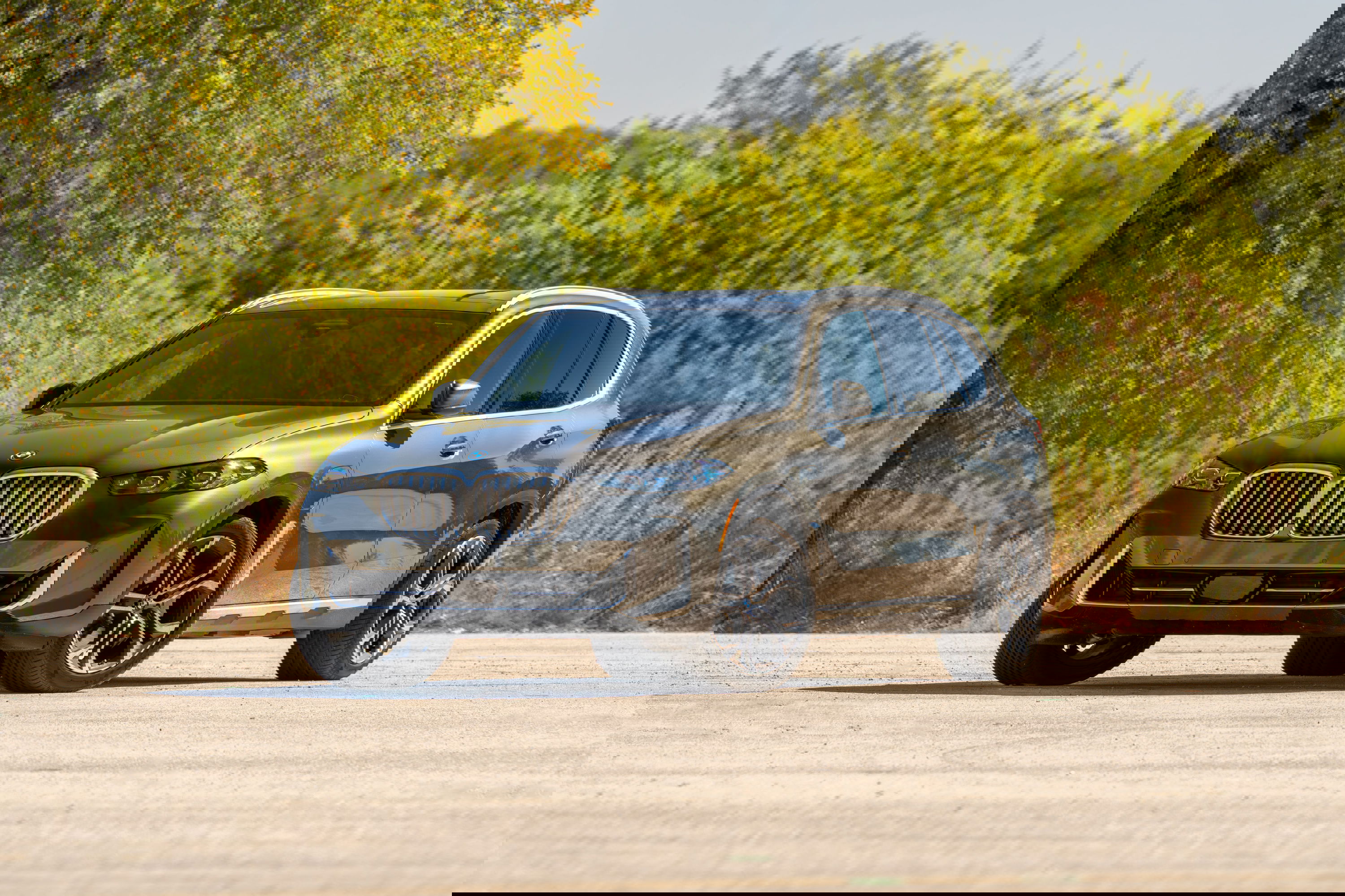 2026 BMW X5 in Manhattan Green metallic with multi-spoke rims and silver trim.