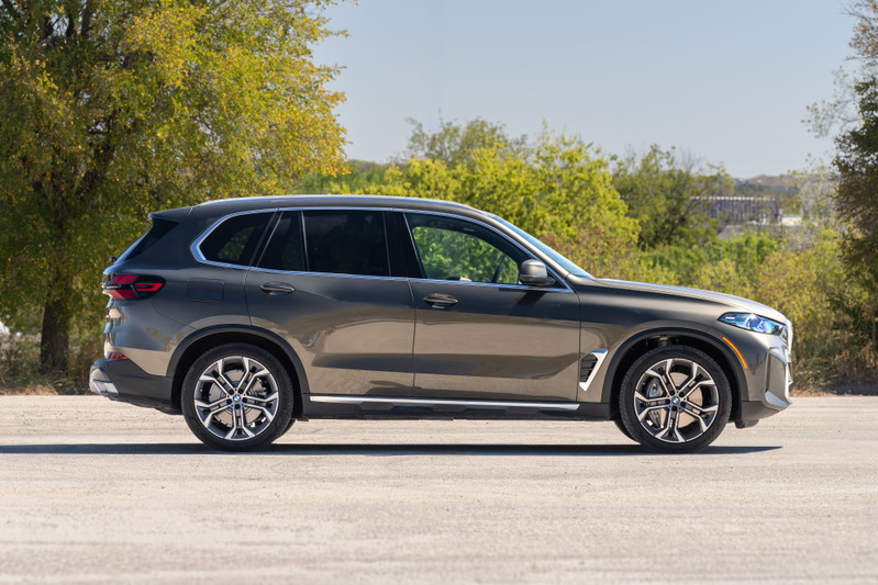 2026 BMW X5 in Manhattan Green features large alloy rims and chrome trim.