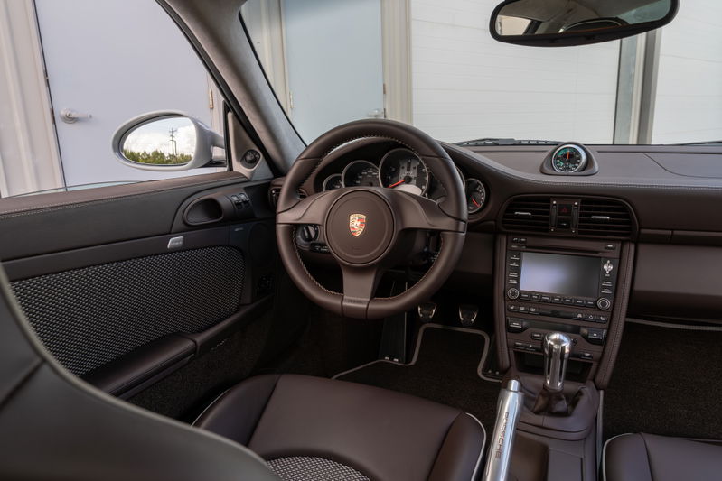 2010 Porsche 911 Sport Classic interior showing leather seats, dashboard, and infotainment system.