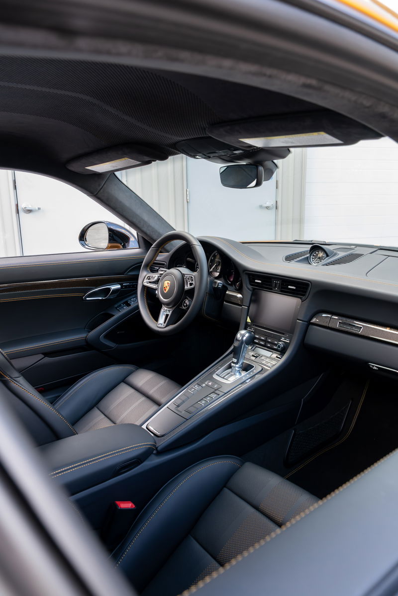 2018 Porsche 911 Turbo S Exclusive Series interior with black leather trim and yellow stitching.