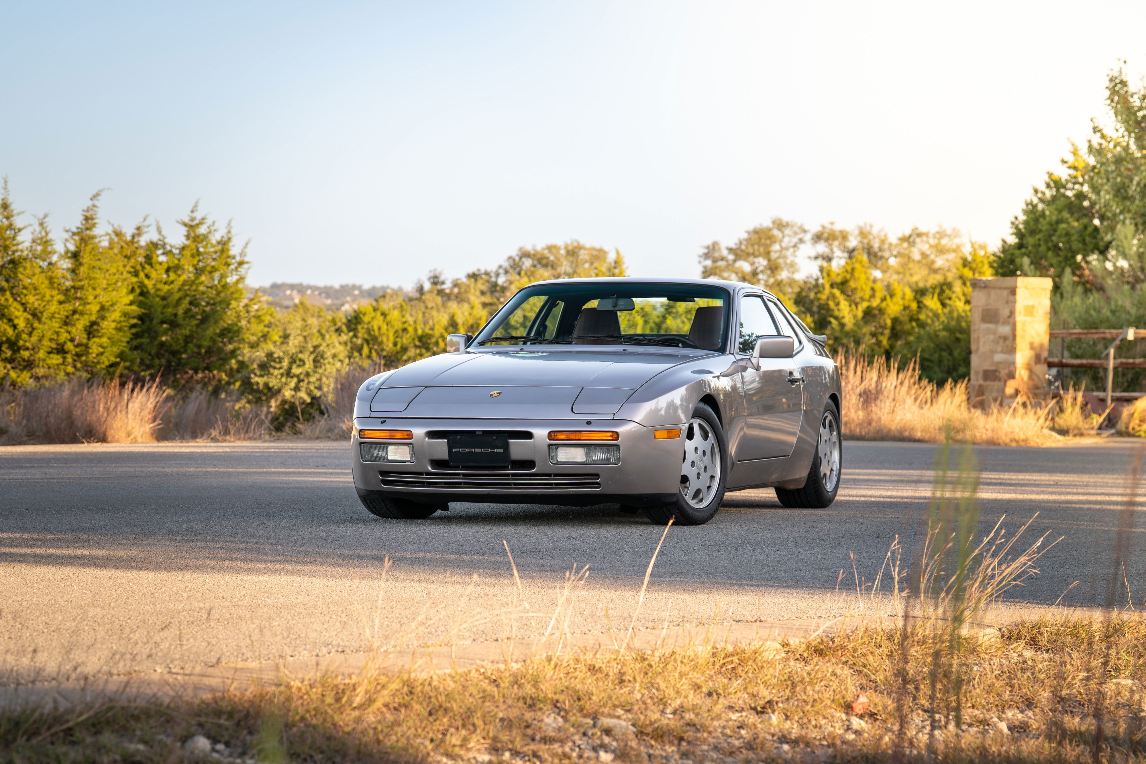 Silver 1987 Porsche 944 Turbo S coupe with alloy rims and black trim.