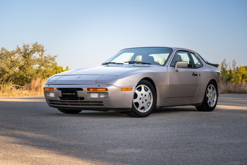 A silver 1987 Porsche 944 Turbo S with five-spoke alloy rims and a rear spoiler.