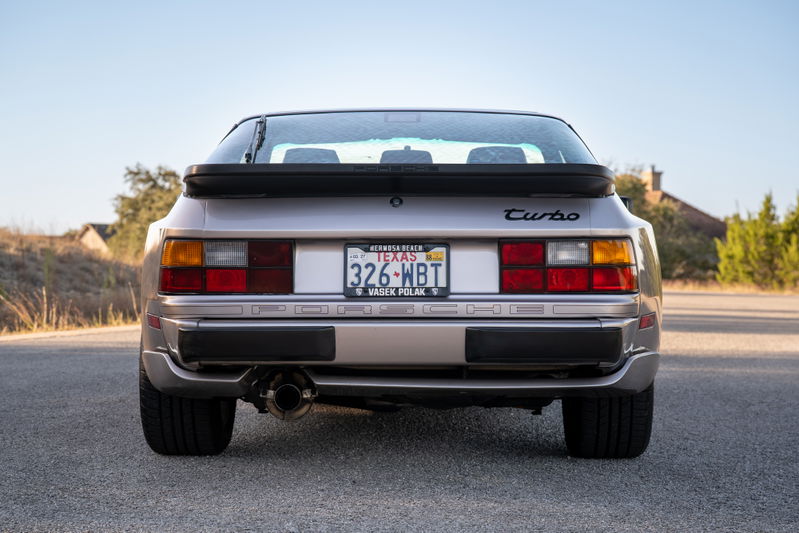 Rear view of a silver 1987 Porsche 944 Turbo S with a black spoiler and "Turbo" badging.