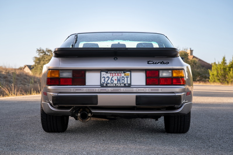 Rear view of a silver 1987 Porsche 944 Turbo S with a black spoiler and "Turbo" badging.