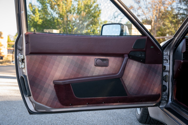 1987 Porsche 944 Turbo S door panel with plaid fabric insert and burgundy trim.
