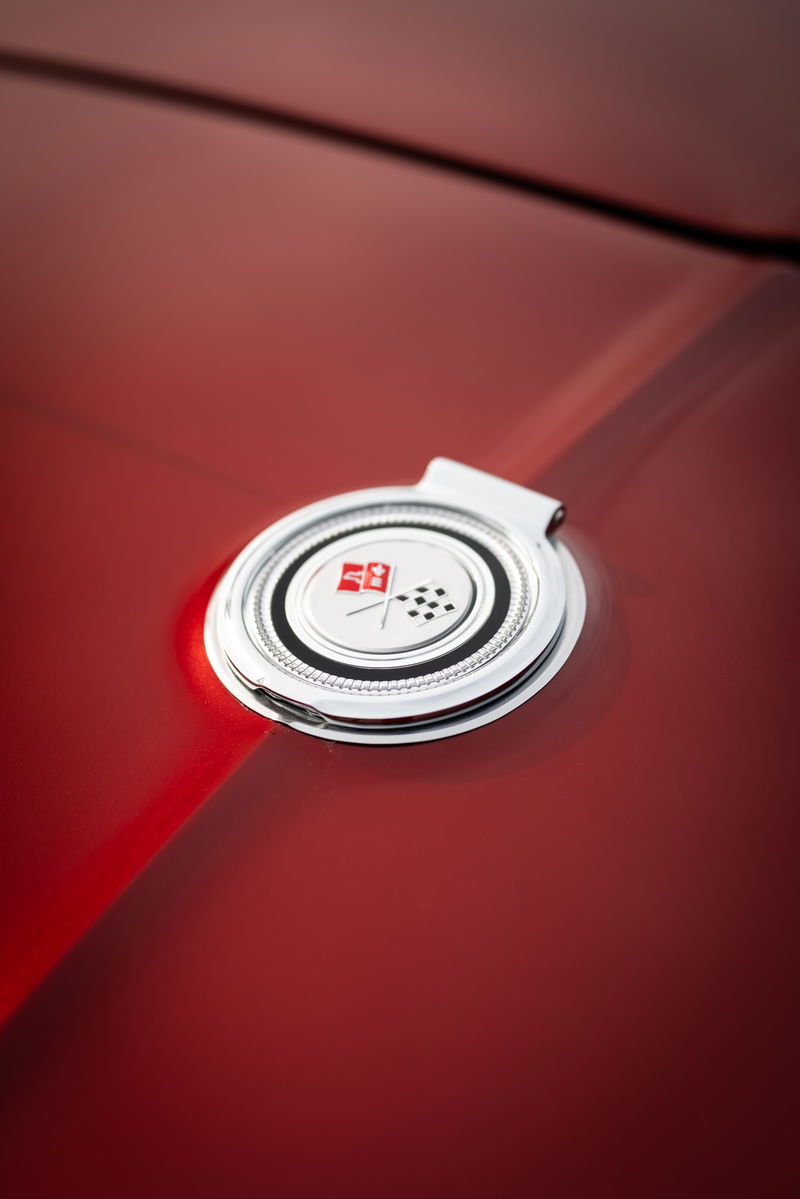Corvette Stingray emblem on red paint.