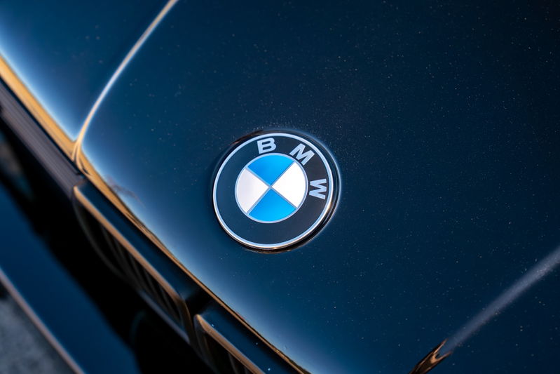 Close up of the BMW emblem on the hood of a black 1989 BMW 325is.