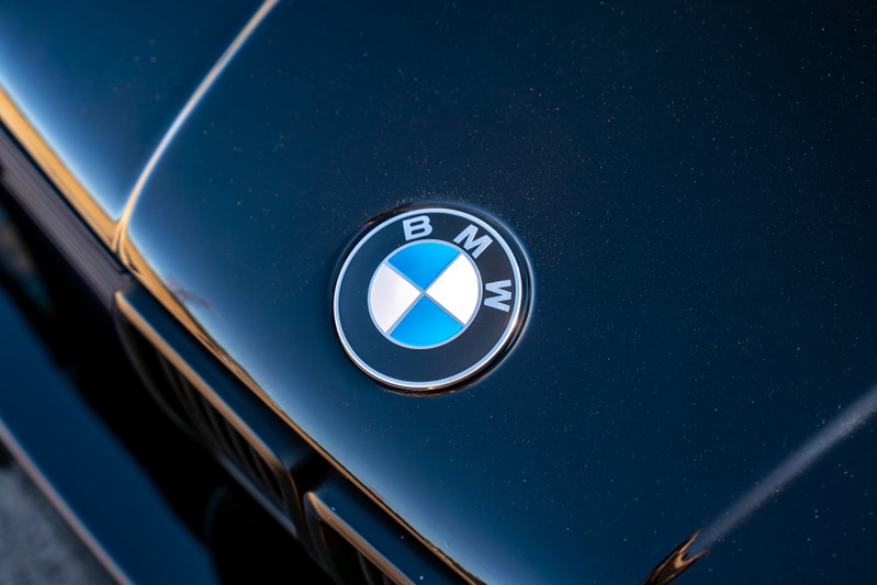 Close up of the BMW emblem on the hood of a black 1989 BMW 325is.