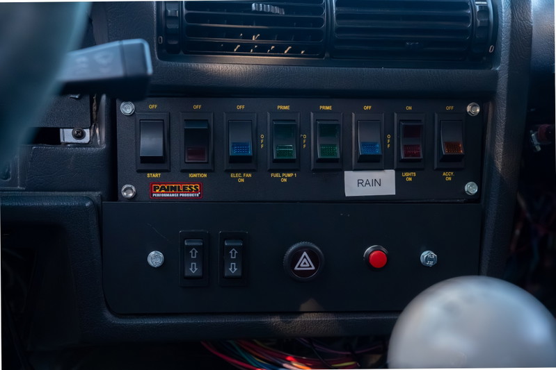Customized dashboard with Painless Performance Products switch panel in a black 1989 BMW 325is.