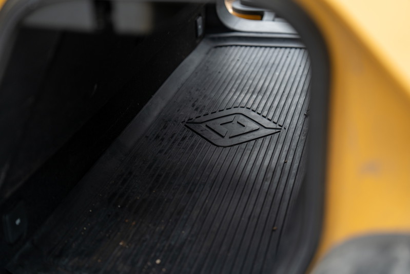 Yellow Rivian R1T pickup truck frunk liner with embossed Rivian logo.