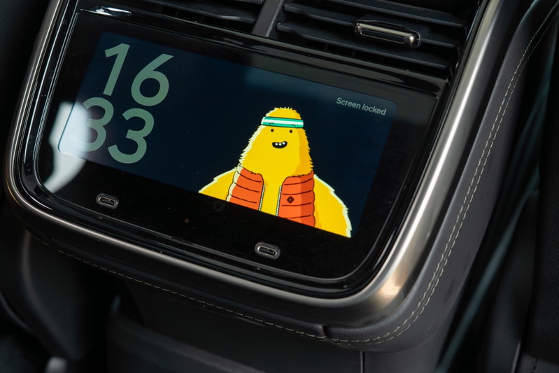 Close-up of a yellow Rivian R1T's rear seat screen showing a cartoon character.