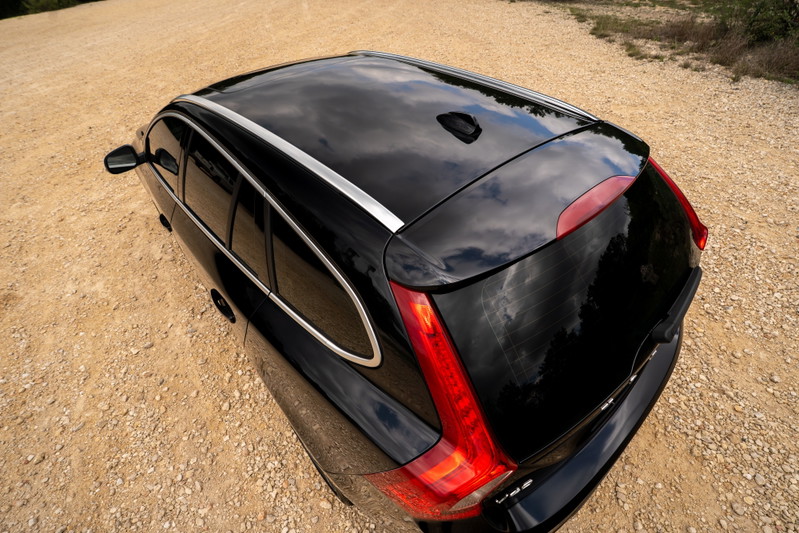 Overhead shot of a black 2015 Volvo V60 R-Design Polestar with chrome window trim and roof rails.