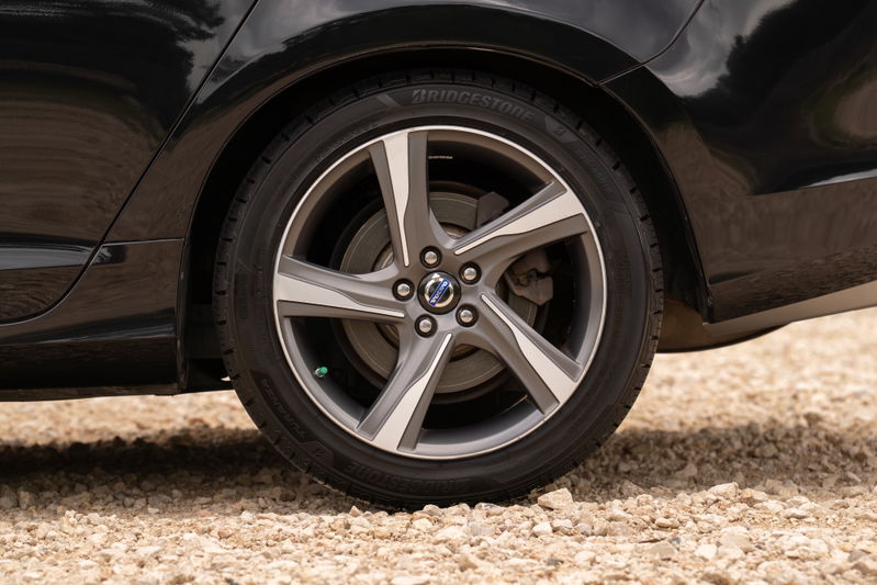 Close-up of a black 2015 Volvo V60 R-Design Polestar's 19-inch diamond cut alloy wheel and tire.