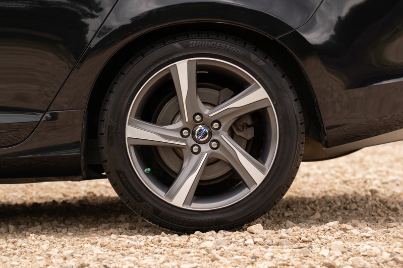 Close-up of a black 2015 Volvo V60 R-Design Polestar's 19-inch diamond cut alloy wheel and tire.