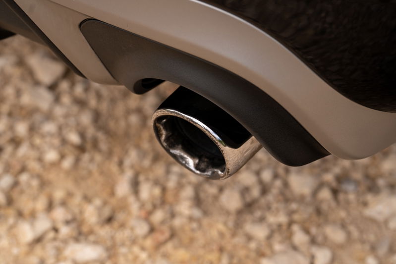 Close-up of a chrome exhaust tip on a 2015 Volvo V60 R-Design Polestar with matte black diffuser trim.