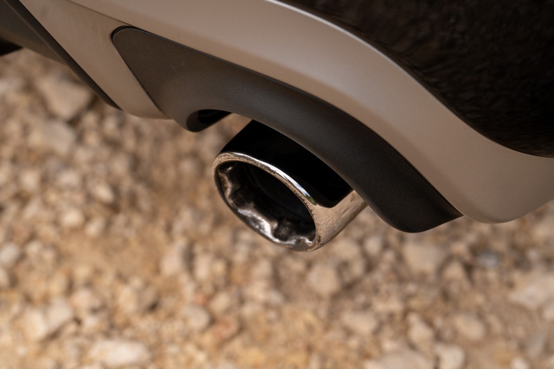 Close-up of a chrome exhaust tip on a 2015 Volvo V60 R-Design Polestar with matte black diffuser trim.