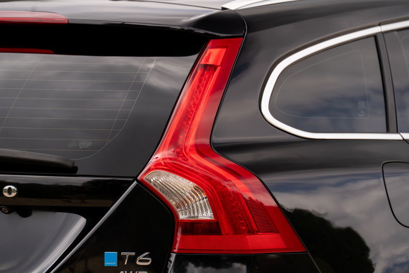Black 2015 Volvo V60 R-Design Polestar T6 AWD taillight and chrome window trim.