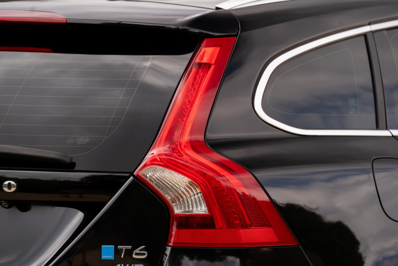 Black 2015 Volvo V60 R-Design Polestar T6 AWD taillight and chrome window trim.