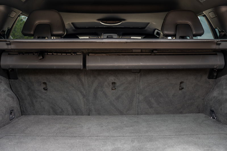 Interior of a 2015 Volvo V60 R-Design Polestar showing the carpeted trunk with cargo cover.