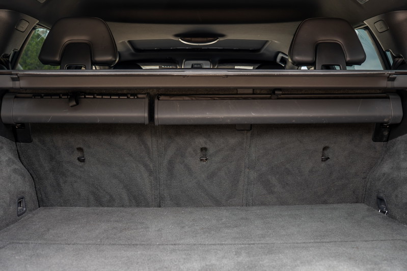 Interior of a 2015 Volvo V60 R-Design Polestar showing the carpeted trunk with cargo cover.