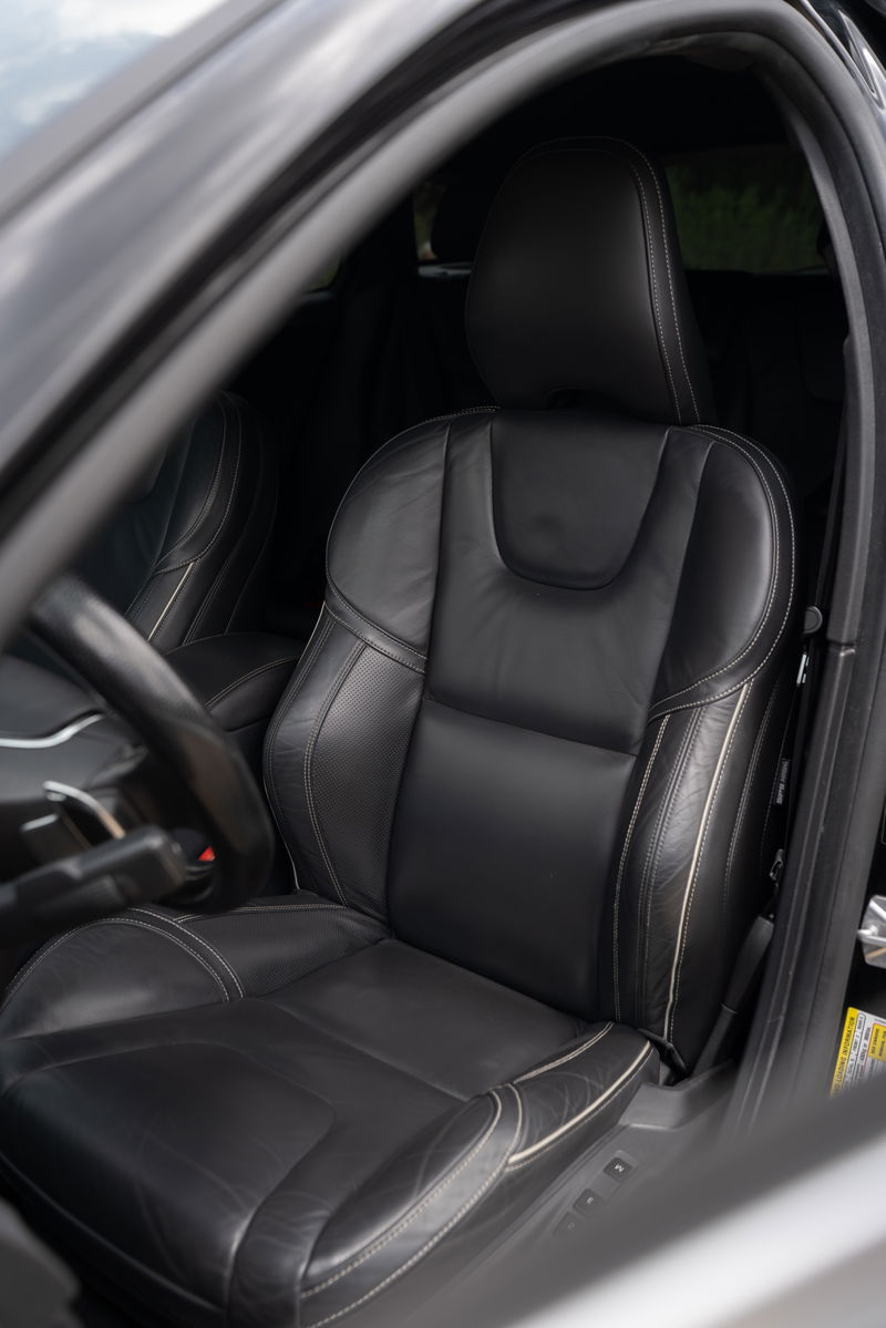 Black leather sport seats with contrast stitching in a 2015 Volvo V60 R-Design Polestar.