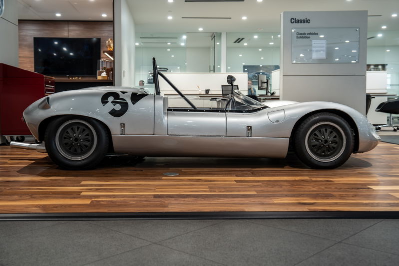 Silver 1964 Elva Porsche 4-Cam race car with black racing livery and multi-spoke rims.