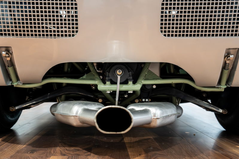 Rear view of a 1964 Elva Porsche 4-Cam with a dual exhaust system and visible suspension components.