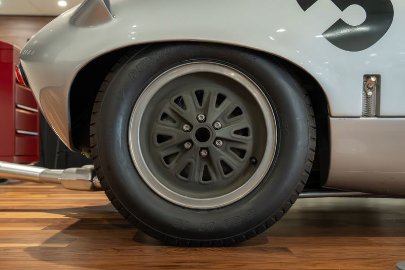 Classic 1964 Elva Porsche 4-Cam race car with grey multi-spoke rims and racing livery.