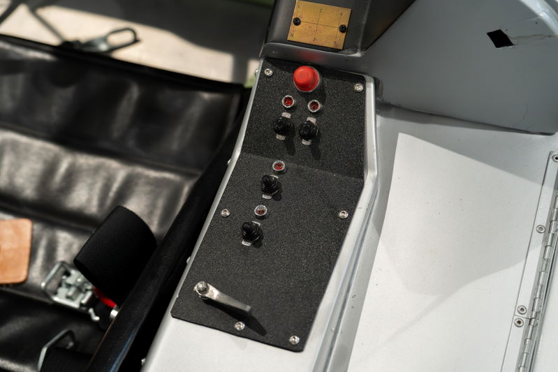 1964 Elva Porsche 4-Cam dashboard with red button and black toggles.