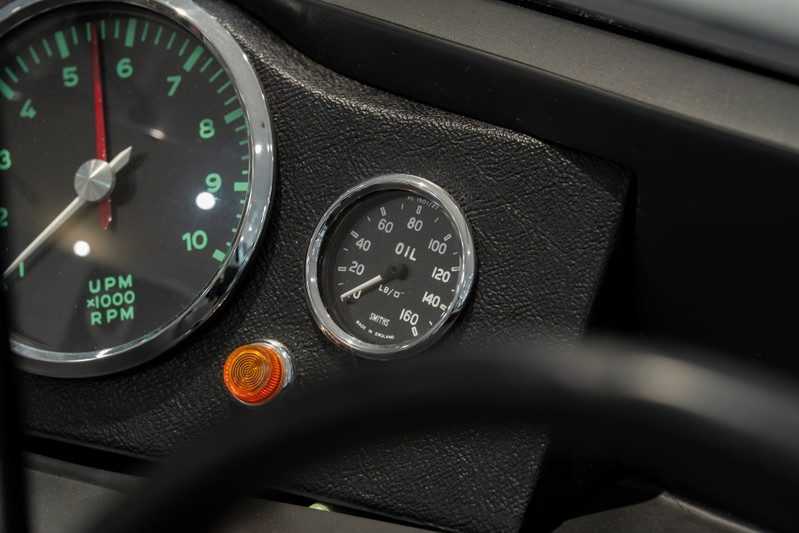 Close-up of the 1964 Elva Porsche 4-Cam dashboard, showing the tachometer & oil pressure gauge.