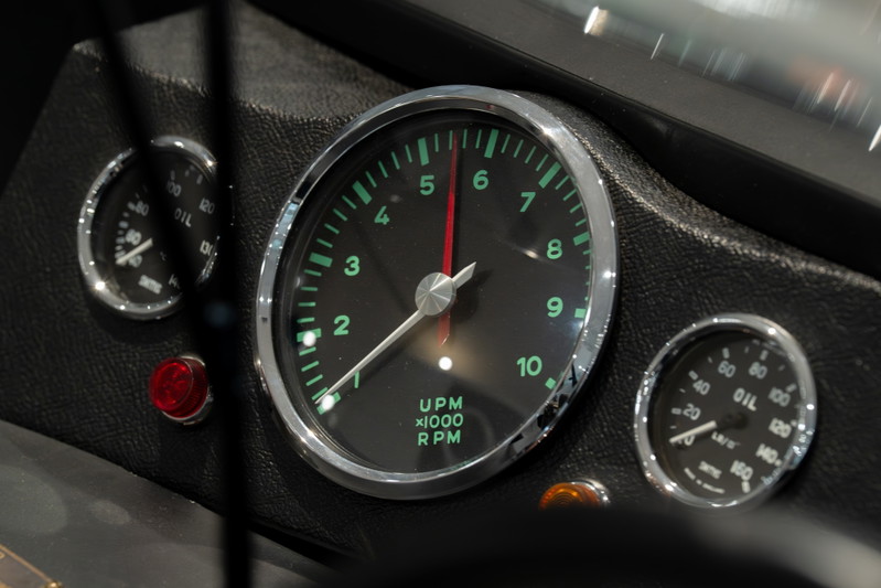 Dashboard of a 1964 Elva Porsche 4-Cam, featuring a tachometer and oil pressure gauge.
