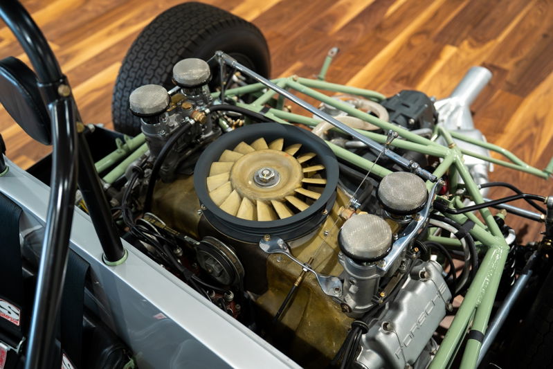 1964 Elva Porsche 4-Cam engine bay with exposed carbs, fan, and green roll cage.