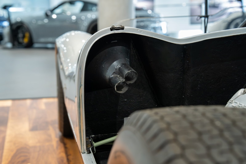 Close-up of a 1964 Elva Porsche 4-Cam's triple exhaust pipes.