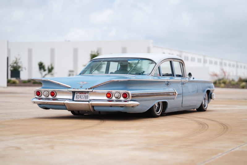 Low-rider 1960 Chevrolet Impala, powder blue, with chrome trim and custom rims.