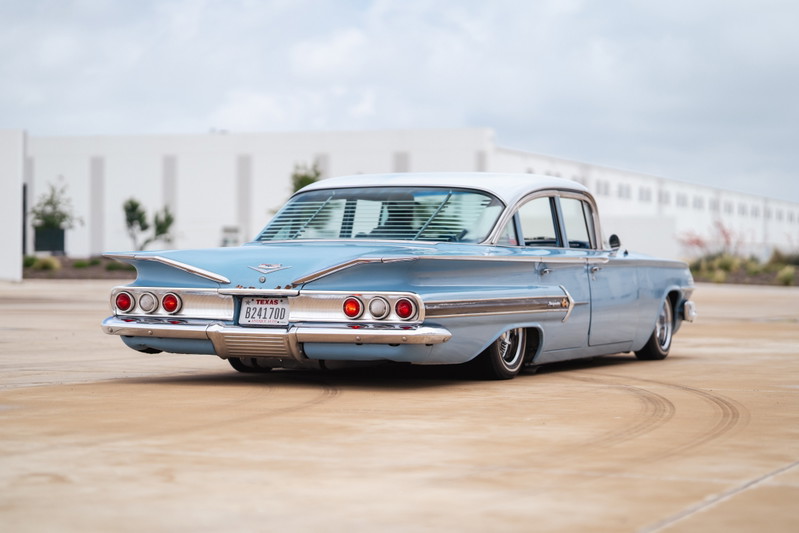 Low-rider 1960 Chevrolet Impala, powder blue, with chrome trim and custom rims.