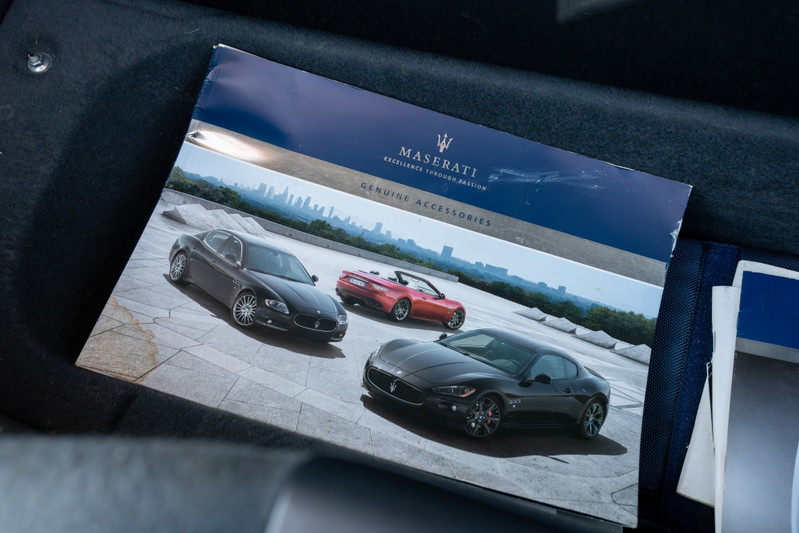 Maserati GranTurismo brochure featuring a black coupe and a red convertible.